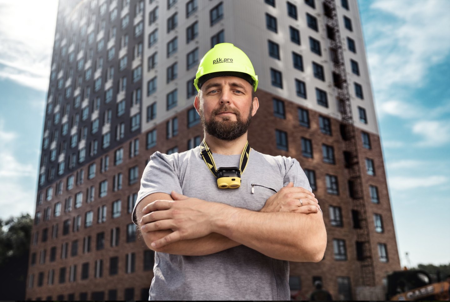 PIK.PRO worker in front of a construction site
